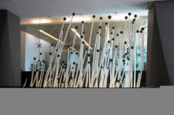 First Forest - Installation by renowned sculptor Elizabeth Thomson for lobby of Vero Tower, Shortland St Auckland. 80 individually lit glass elements up to 4.5 metres in height